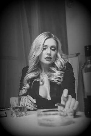 104563446-sexy-attractive-blonde-woman-holding-cig